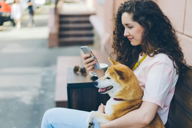 A woman with her corgi outdoors